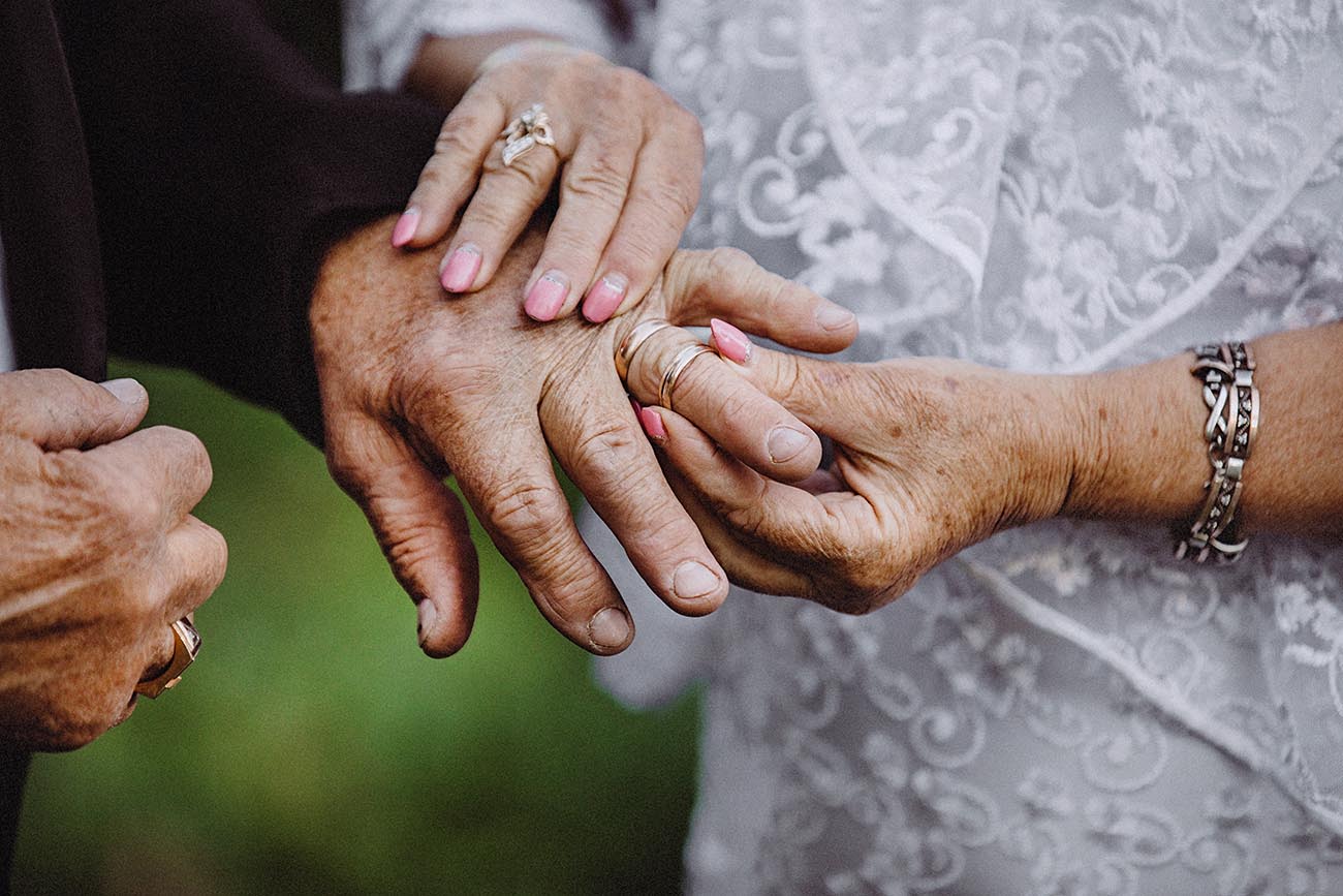 old couple placing ring